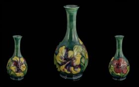 William Moorcroft Signed Bulbous Shaped Tube lined Vase ' Hibiscus ' Variations Design on Emerald