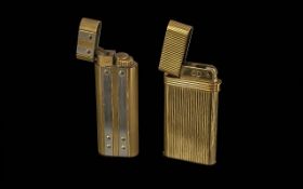 Two Lighters to include Cartier Paris two tone lighter, and a Christian Dior, both in gold tone.