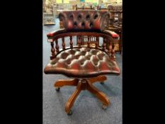 Captain's Chair, Ox Blood Leather, button back and seat, five splayed legs on casters, turned