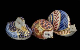 Royal Crown Derby Paperweights, comprising Orchard Hedgehog, Duck, and Snail. All with gold