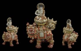 Oriental Foo Dog, with figure sitting on top, highly decorated with gilt. Measures approx. 10'' high