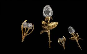 Two Swarovski Crystal Set Brooches, comprising a rose brooch 3.5'' high, and a brooch with two