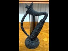 19th Century Irish Carved Bog Oak Model of a Harp, the body carved with shamrocks, 9'' high. Crack