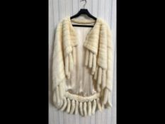 Beautiful Ladies Cream Mink Cape, with tails to edges. Fully lined in sateen fabric, front hook