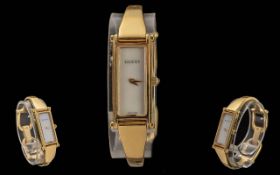 Gucci 1500L Ladies Gold Plated Wristwatch, gold tone, white dial with gold hands, bangle strap. With
