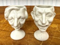 Two Collectible Egg Cups created by Luck & Flaw for Spitting Image. White pottery in the form of