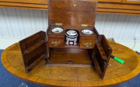 Mahogany table top smoker's cabinet with two front opening doors featuring carved panel design,