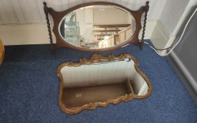 An Oak Framed Bevelled Mirror, barley twist sides, measures 17'' x 33''. Together with one other