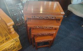 Nest of Four Carved Hardwood Interlocking Chinese Nestling Tables - Padouk. Height 26''.