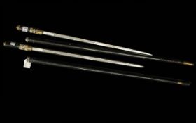 Two Vintage Indian Sword Sticks, with a brass lion to the handle, and carved bone decorations.