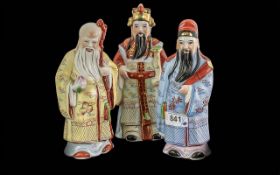 Set of Three Chinese Deity Porcelain Figures, highlighted in gilt work. 8'' high.