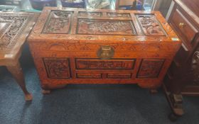 A Large Sized Profusely Carved Chinese Camphor wood box, the deeply carved top and sides depicting