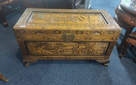 Carved Chinese Camphor Wood Box, profusely decorated with Chinese figures in a garden setting,