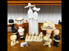 Lladro Figure of Two Nuns, with a collection of Lurpak Butter pottery advertising figures.