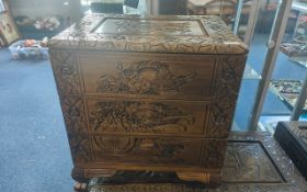 A Matched Pair of Carved Chinese Three Drawer Bedside Cabinets, profusely carved to the top,