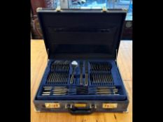 Canteen of Cutlery housed in a briefcase style case, stainless steel and gilt cutlery marked