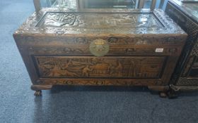 A Profusely Carved Chinese Camphor Wood Trunk, carved to the top and sides with formal Chinese