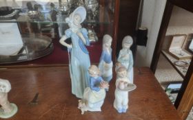 Four Nao Figures, includes 13.5'' elegant lady, two young girls, girl with a cake and puppy, and a
