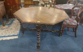 A Large Hexagonal Shaped Victorian Carved Oak Centre Table, supported on candy twist carved legs