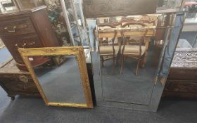 Two Mirrors, comprising a gilt framed mirror and a panelled mirror. Largest measures 36'' x 26''.