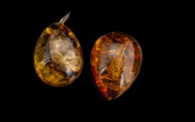 Two Reconstituted Amber Pendants, both w
