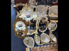 A Collection of Mirrors, comprising a distressed Rococo style, a triple dressing table mirror,