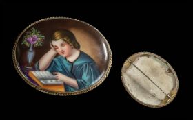 Continental Painting on Porcelain Brooch, depicts a young girl reading, mounted in a 9ct unmarked