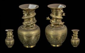 Pair of Brass Chinese Vases, circa 1900, decorated with three dimensional dragons twisted around the