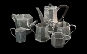 Two Art Deco 1930's Three Piece Beaten Pewter Tea Sets, with faceted sides stamped to the base. Hand