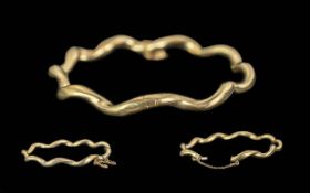 Ladies Fine 9ct Gold Hinged Bangle with Safety Chain. Marked 9ct. Twist Design. Weight 8.2 grams.