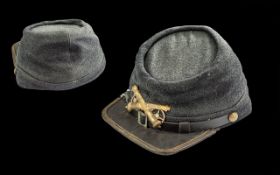 American Civil War Grey Cloth Troopers Hat, emblazened with a pair of brass cannons, with wheels.