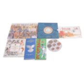 Collection of coin sets and coins.