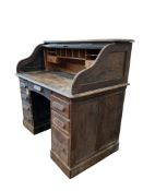 An early 20th century American oak roll top desk, width 120cm, depth 70cm, height 115cm