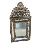A small French embossed brass wall mirror, width 32cm, height 60cm