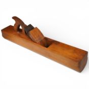 A Buck beech curved sole jointer plane fitted with a Ward 2 1/2” iron, stamped ‘Buck, 242