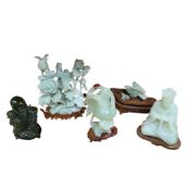 A group of jade type hardstone carvings, 20th century, comprising a flower and bird group (damages),