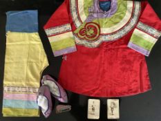 An early 20th century Chinese child’s silk robe and trouser set and a pair of embroidered pink