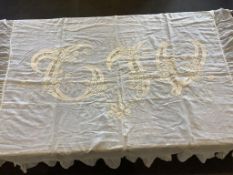 A 19th century cream coloured ‘white worked’ fine lawn bed cover, embroidered with a large central