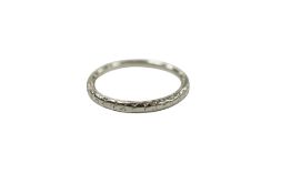 An engraved white metal wedding band stamped 'Platinum', size H/I, 2.8 grams.