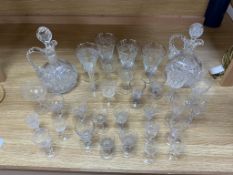 Two lead crystal ewers and a quantity of drinking glasses, some with etched decoration, largest ewer