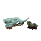 A bowenite jade type Rhyton and dragon, 20th century each with a stand. Larger 14cm wide. (2)