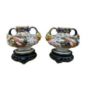 A pair of Crown Derby Imari pattern, vases with gilt mask handles, lacking covers, with carved