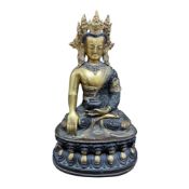 A Nepalese jewelled gilt bronze Shakyamuni Buddha on oval petalled base, height 31cm.