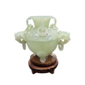 A bowenite jade censer, 20th century, on tripod supports and with a hardwood stand.16.7cm high