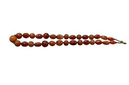 A carnelian bead necklace, India, composed of spherical and tonneau shaped beads of carnelian,