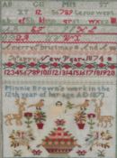 A 19th century wool worked sampler by Minnie Brown, aged twelve years, dated 1873. A colourful