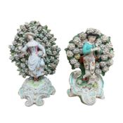 Two Derby bocage porcelain figures of a gentleman with a dog and a lady, largest 29cm high