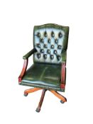 A green leather button back swivel desk chair, width 60cm, depth 60cm, height 103cm