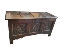 An 18th century carved oak coffer, width 127cm, depth 51cm, height 66cm