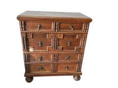 A Jacobean Revival oak geometric chest of drawers, width 92cm, depth 50cm, height 106cm